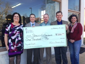 Strawn & Co agents pose with check for facade grant program