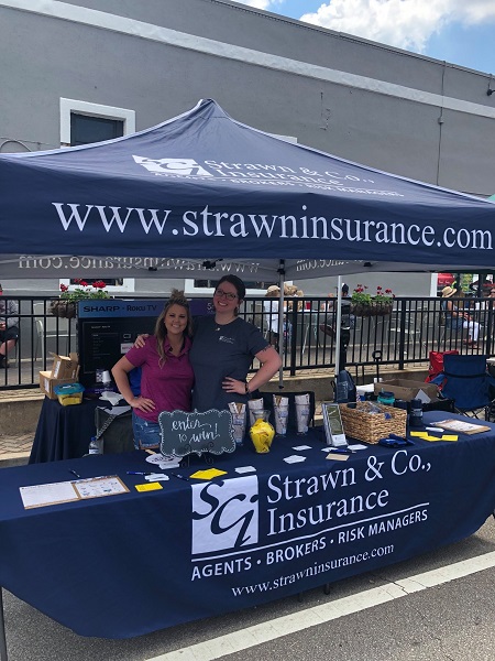 Two agents at the Strawn & Co tent at the Geranium Festival