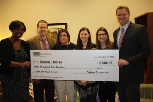 Strawn & Co Agents holding a large check for Haven House