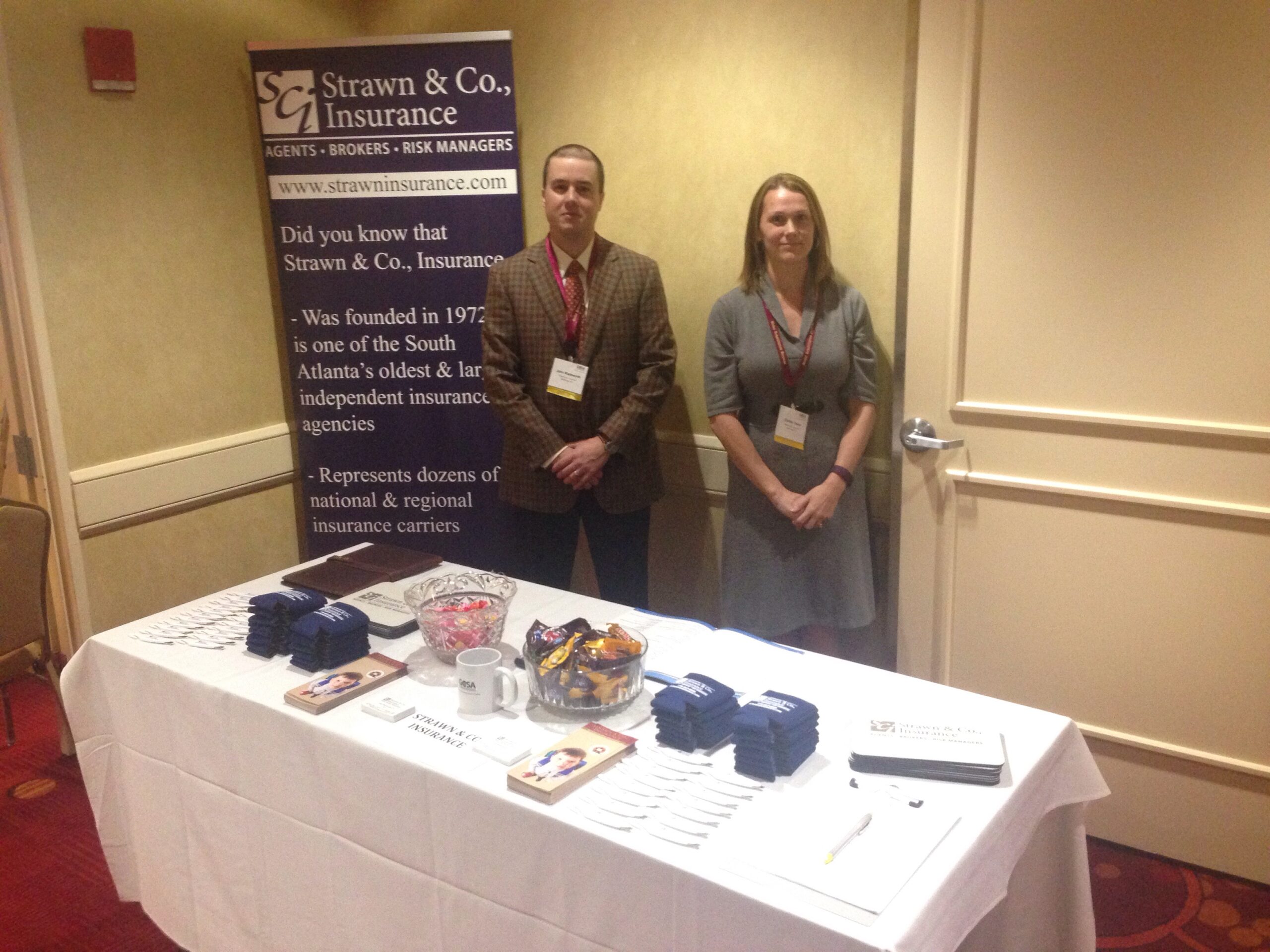 Two agents at the Strawn & Co table at the Georgia Charter School Association conference